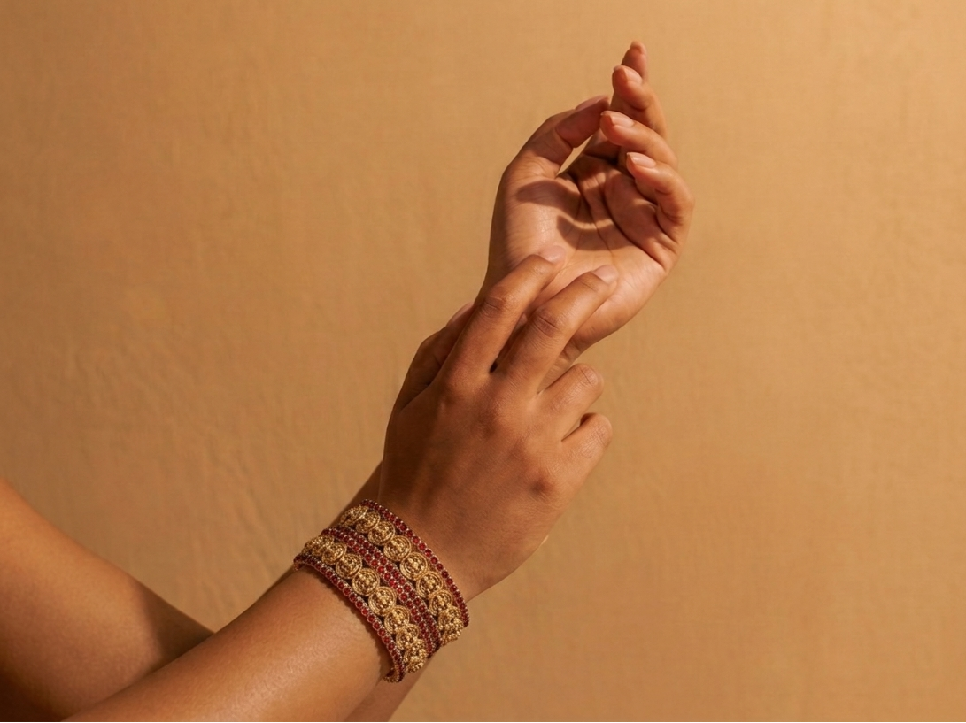 Close-up of a person's hand wearing a bracelet against a beige background