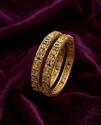 Gold bracelet with gemstones on a purple velvet background