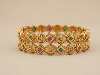 Gold bracelet with gemstone accents on a beige background