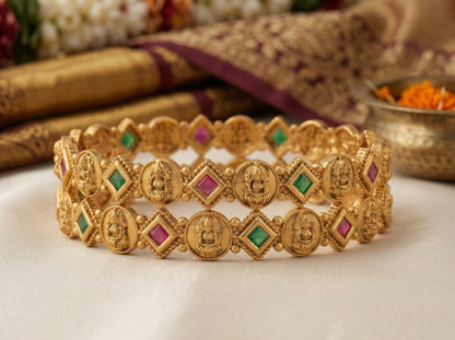 Gold bracelet with gemstones on a white background