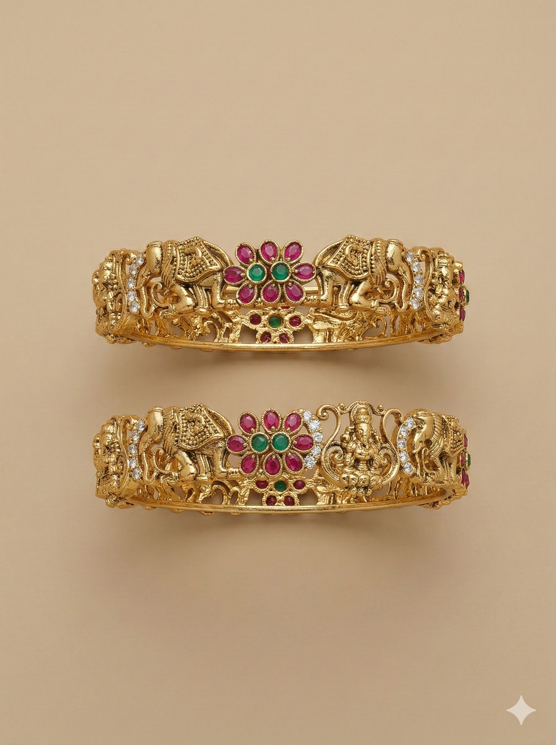 Pair of gold bangles with elephant and deity designs on a beige background