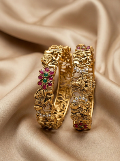 Gold bangles with gemstones on a beige fabric background
