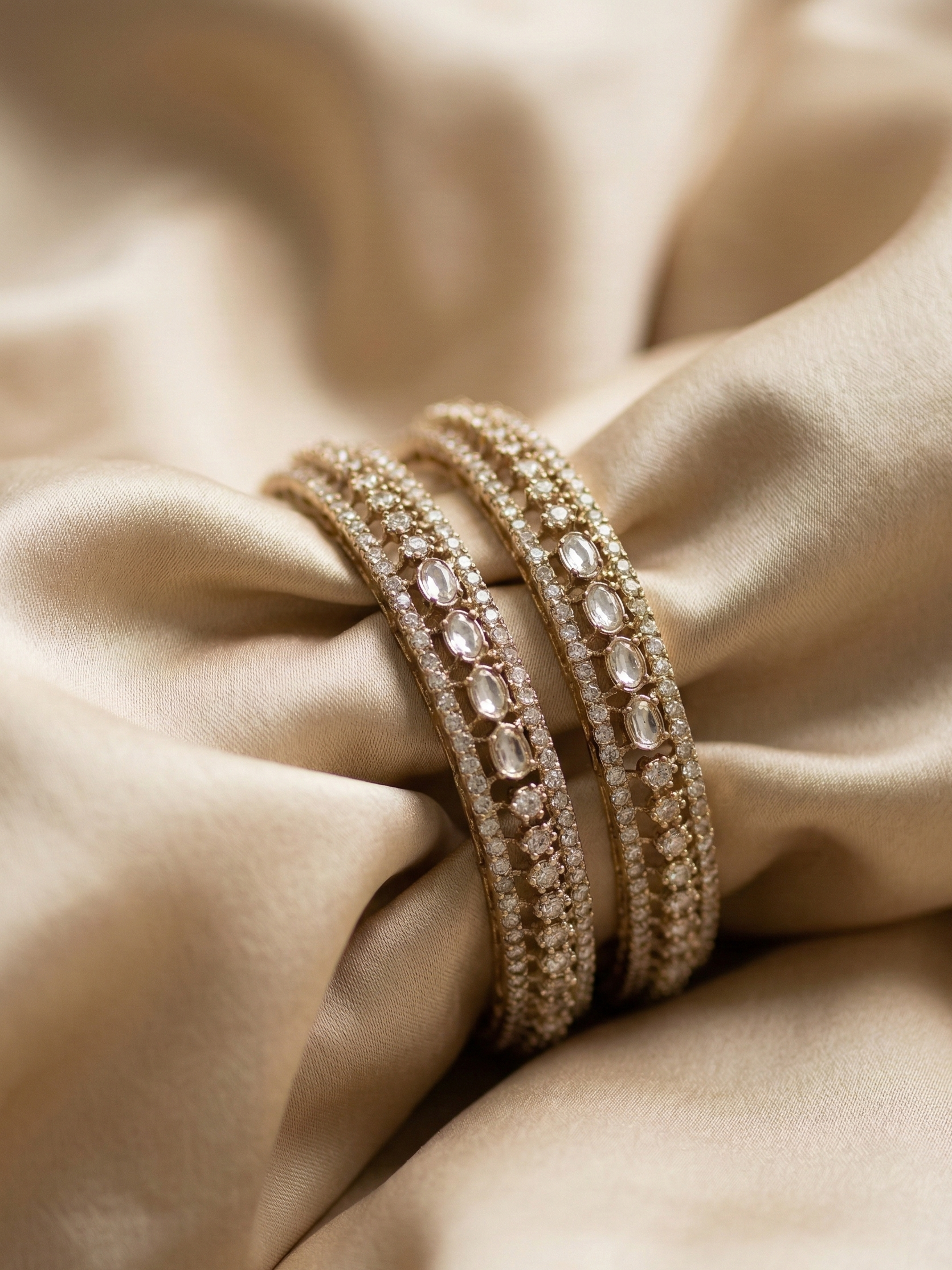 Close-up of a gold bracelet on a beige fabric background