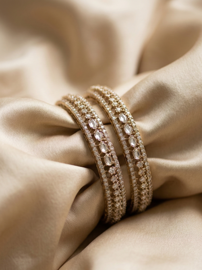 Close-up of a gold bracelet on a beige fabric background